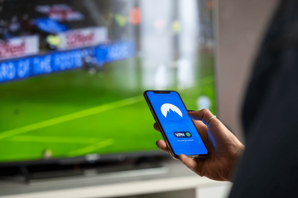 Viewer comparing streaming services on multiple devices under the same viewing conditions.